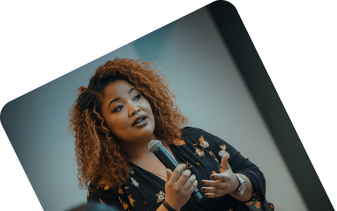 A community creator speaking into a microphone