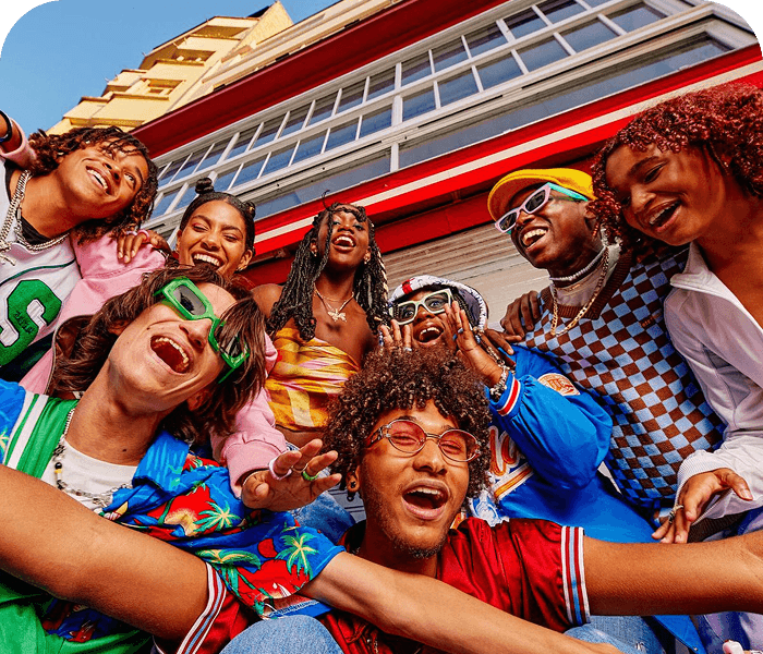 A group of friends laughing together on a street